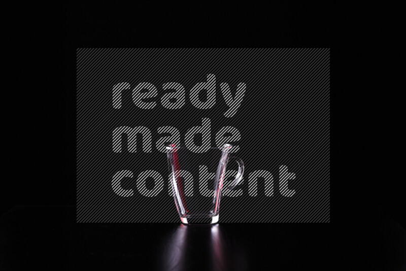 Glassware with rim light in red and white against black background