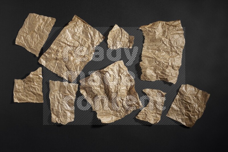 Crumpled craft paper on black background