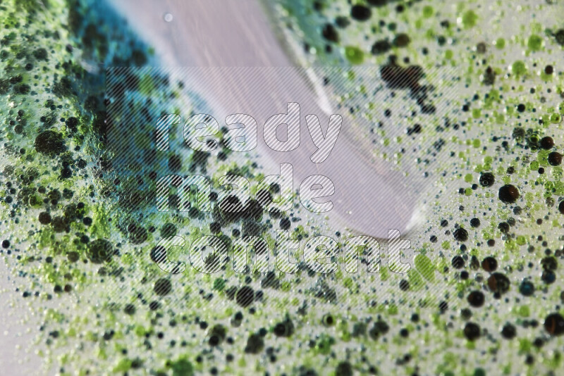 Close-ups of abstract green and blue watercolor drops on oil Surface on white background