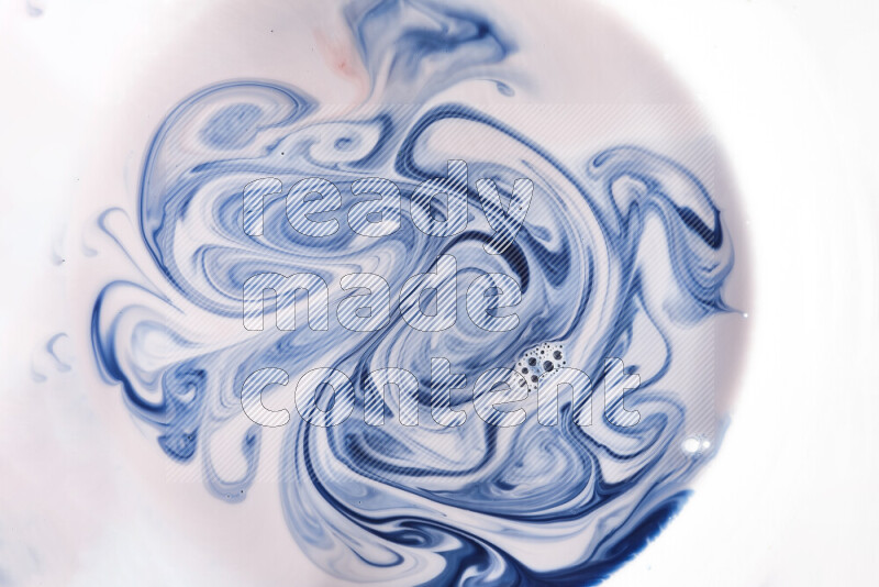 A close-up of abstract swirling patterns in blue, red and white