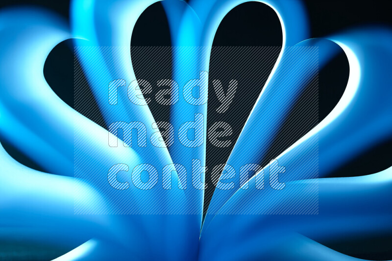 An abstract art piece displaying smooth curves in white and blue gradients created by colored light