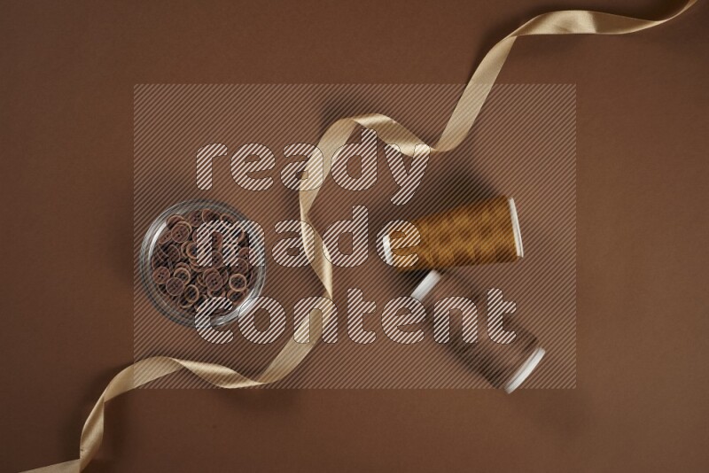 A brown collection of sewing and tailoring tools arranged on a brown background