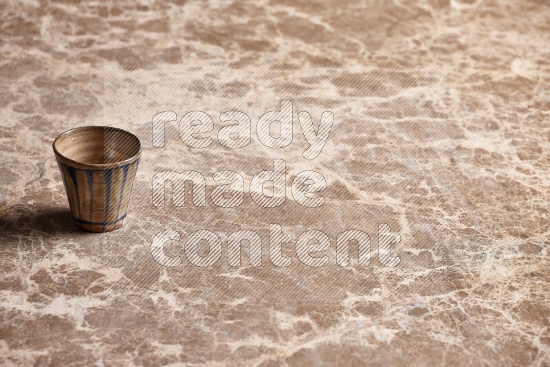 Pottery Cup on Beige Marble Flooring