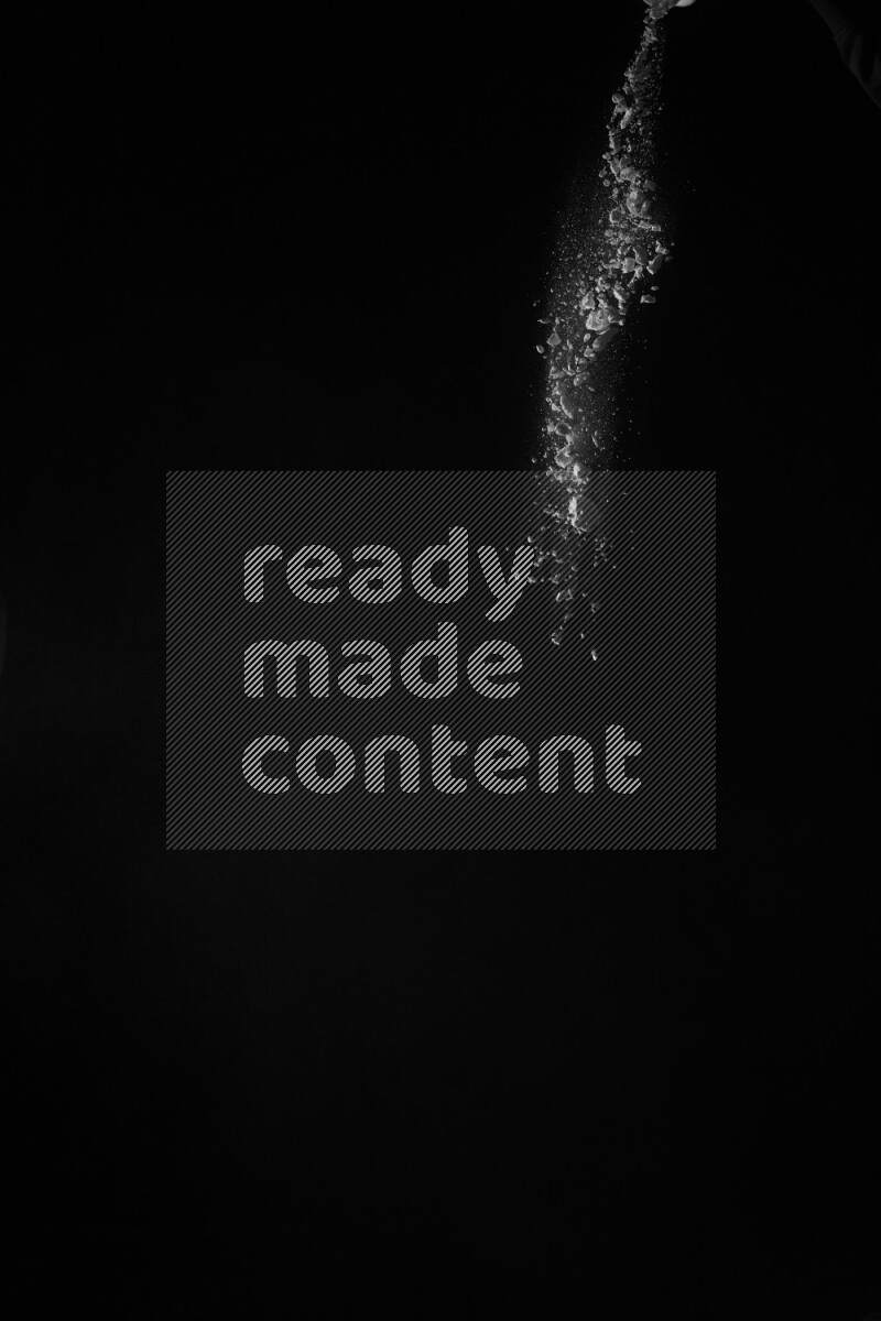 A side view of white powder explosion on black background