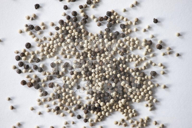 Mixed black and white pepper beads on a white flooring