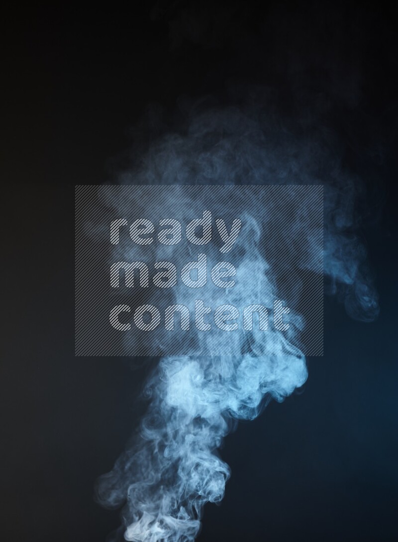 Heavy smoke in blue and yellow isolated on black background