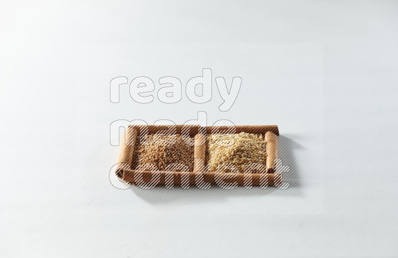 2 squares of cinnamon sticks full of mustard seeds and sesame on white flooring