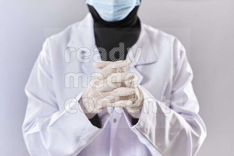 Female doctor wearing an abaya and medical attire in different positions
