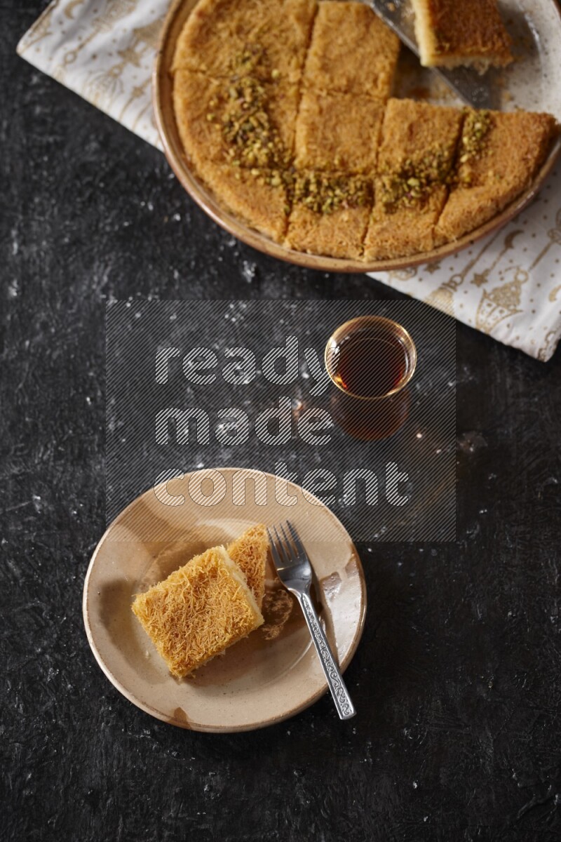 konafa with tea in a dark setup
