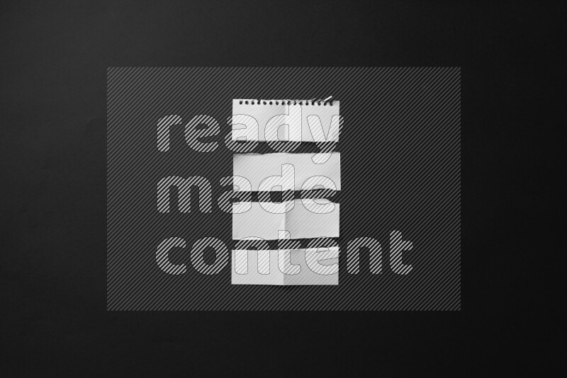 Ripped notebook sheet on black background