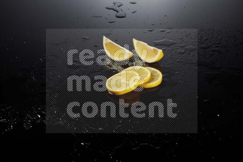 Lemon slices with water drops, and droplets on black background