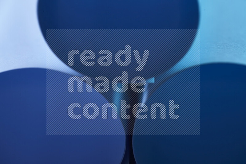 The image shows an abstract paper art with circular shapes in varying shades of blue