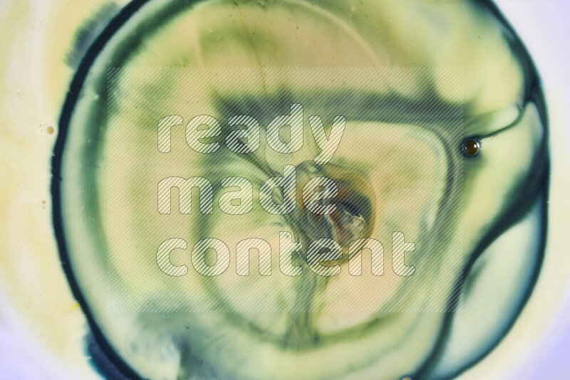 A close-up of abstract swirling patterns in yellow and green