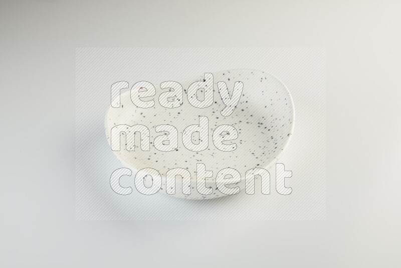 white plate with black dots on white background