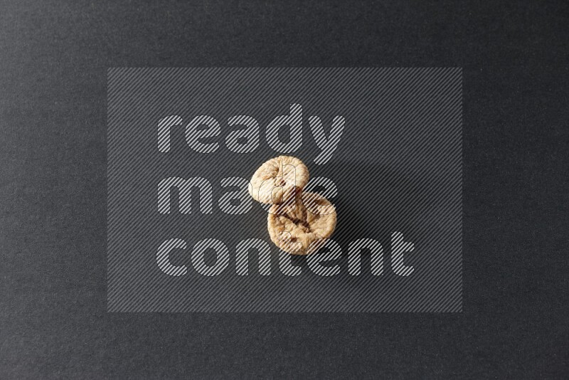 Two dried figs on a black background in different angles
