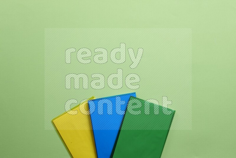 Multicolored notebooks on green background