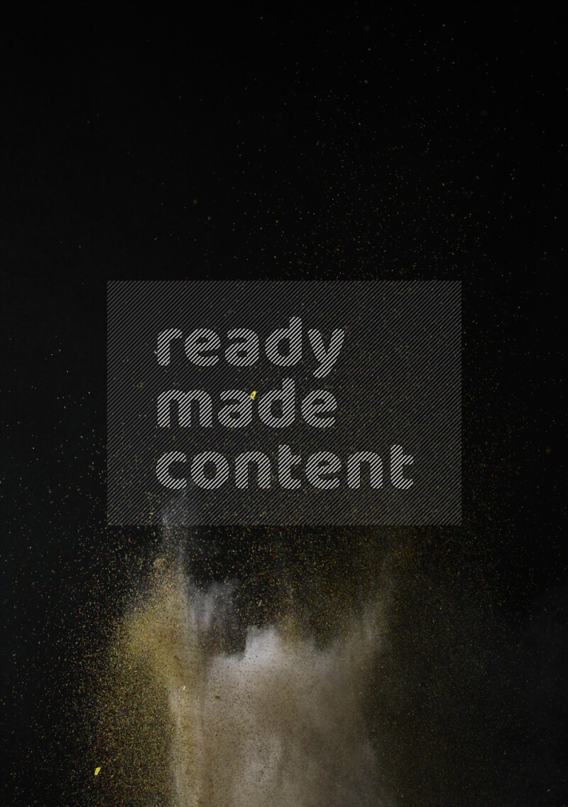 A side view of brown powder explosion on black background
