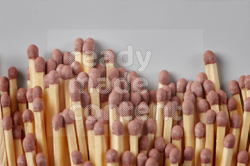 A close-up of a bundle of matches on grey background
