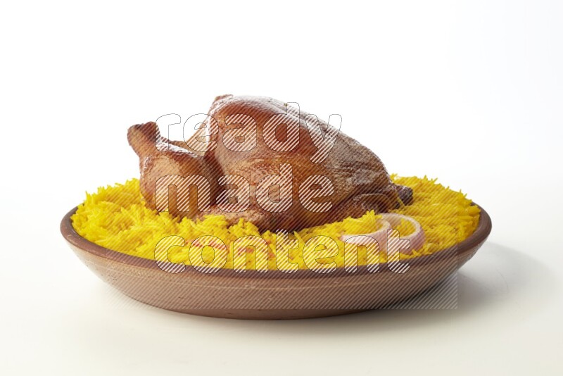 yellow basmati Rice with whole roasted chicken  on a pottery plate  direct  on white background