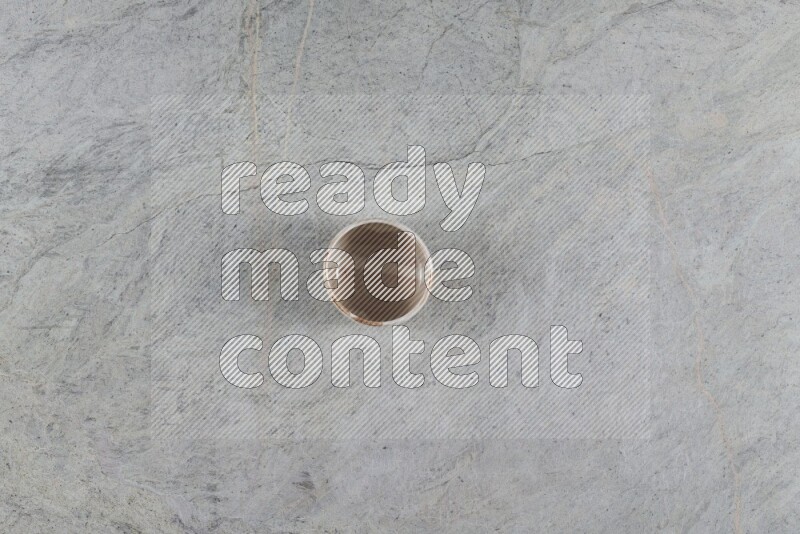 A multicolored pottery Bowl on grey marble background