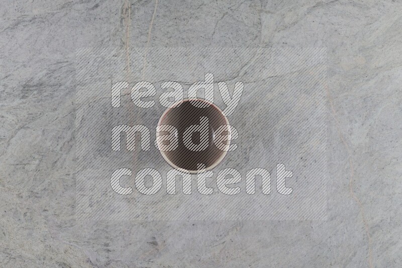 A multicolored pottery Bowl on grey marble background