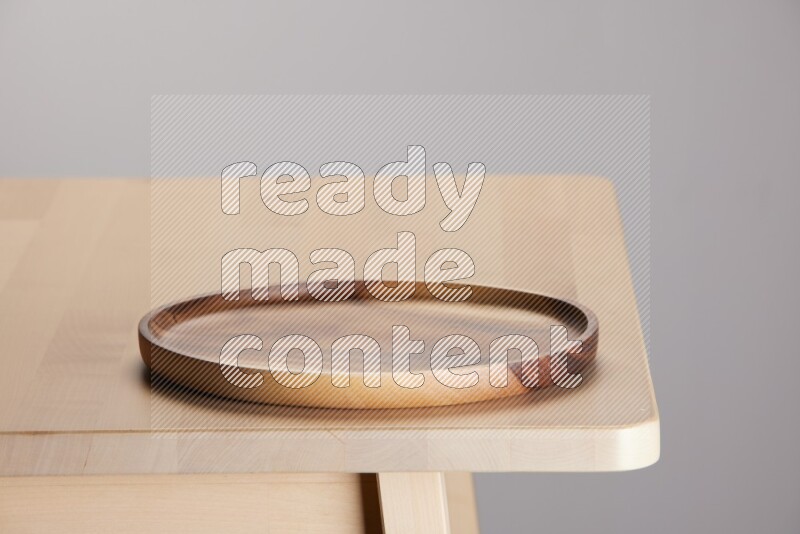 wooden trays and cutting boards on the edge of wooden table