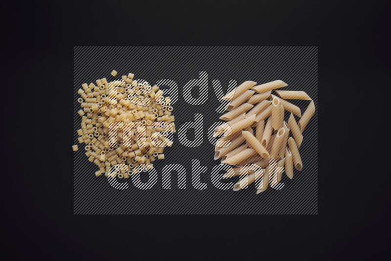 Different pasta types in bunches on black background