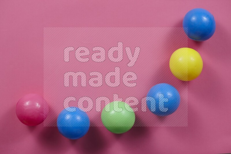Multicolored plastic balls on different colored backgrounds (kids toys)
