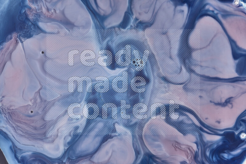 A close-up of abstract swirling patterns in blue, red and white