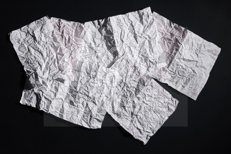 Crumpled notebook sheet on black background