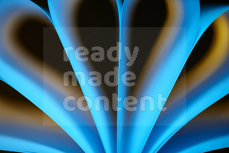 An abstract art piece displaying smooth curves in yellow and blue gradients created by colored light