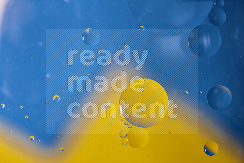 Close-ups of abstract oil bubbles on water surface in shades of blue and yellow