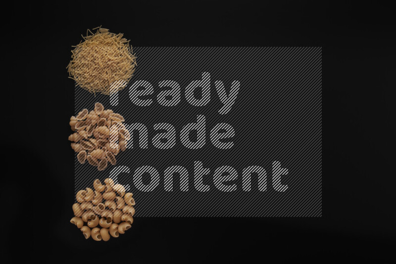 Different pasta types in 3 bunches on black background