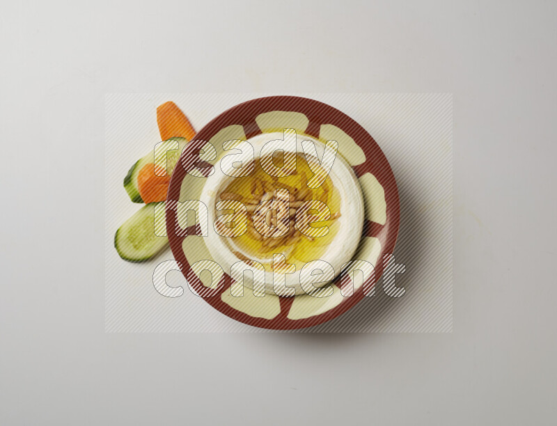 Lebnah garnished with pine nuts in a traditional plate on a white background