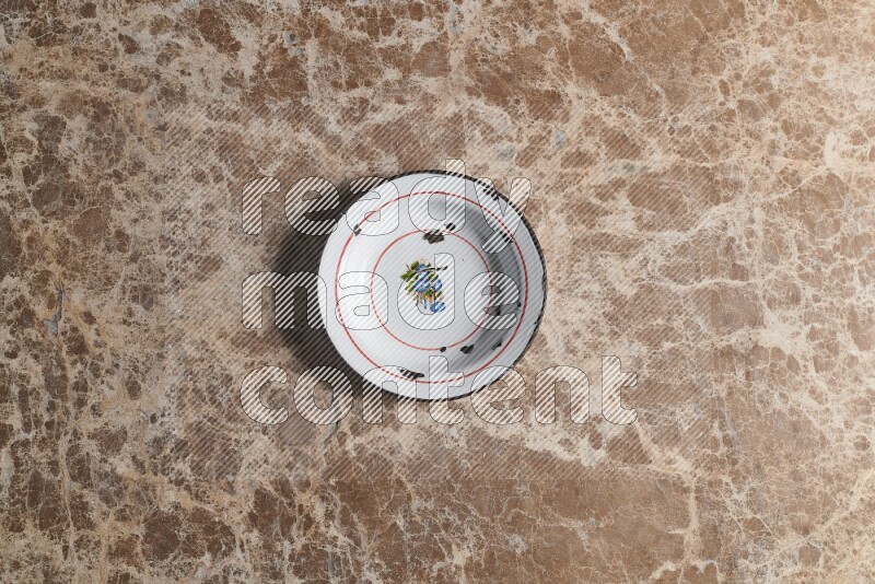 A vintage metal plate on beige marble background