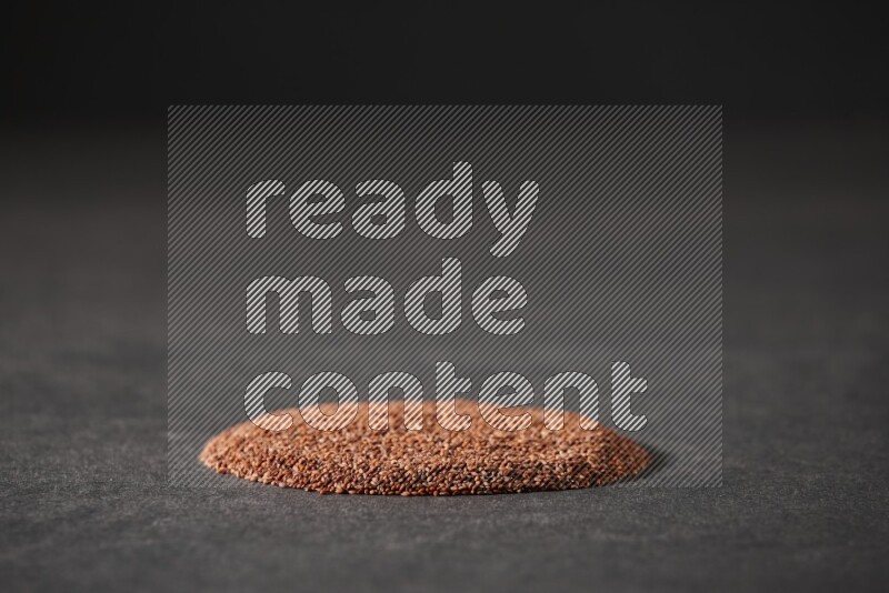 Garden cress seeds in a circle shape on a black flooring