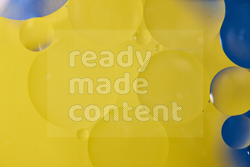 Close-ups of abstract oil bubbles on water surface in shades of blue and yellow