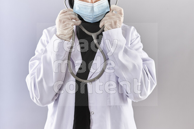Female doctor wearing an abaya and medical attire in different positions