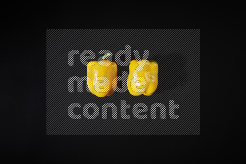 Yellow bell pepper on black background