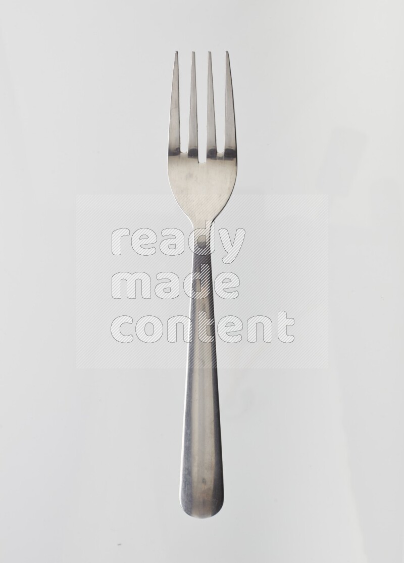 Silver stainless steel fork on white background