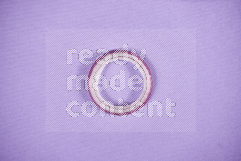 Red onions rings on purple background