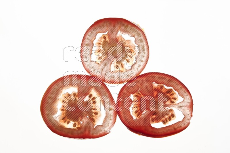 Tomatoes slices on illuminated white background