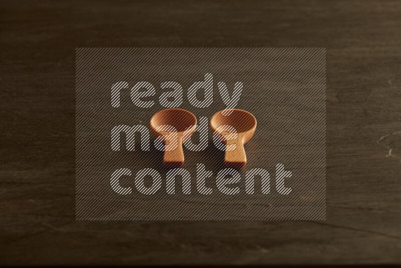 wooden spoon on black slate background