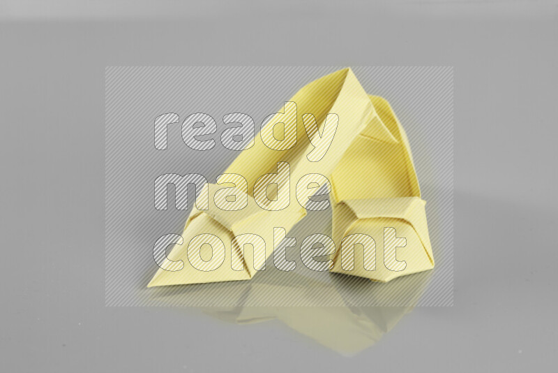 Origami shoes on grey background
