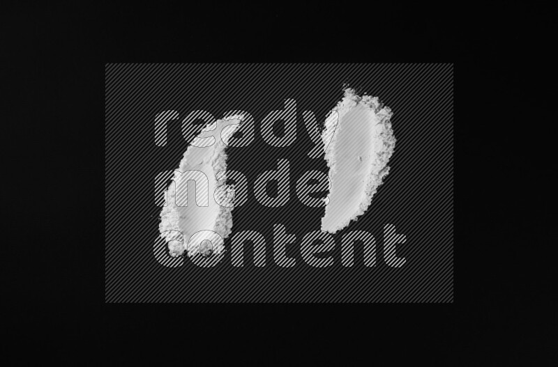 White powder smears on black background