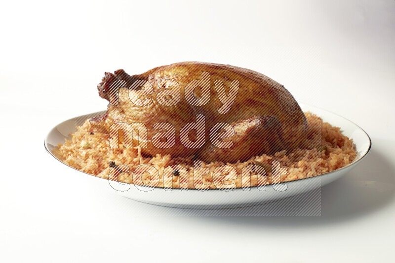 red basmati Rice with whole roasted chicken on a white plate with a silver rim direct on white background