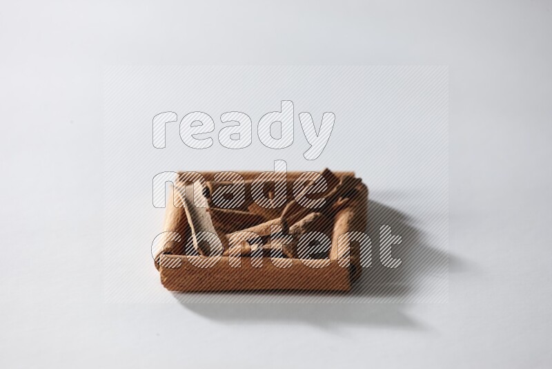 A single square of cinnamon sticks full of cinnamon on white flooring