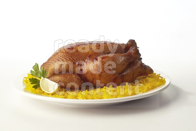 yellow  basmati Rice with  whole roasted chicken on a white rounded plate direct on white background
