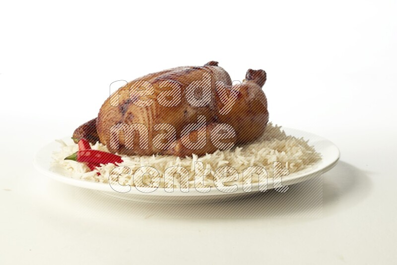 white  basmati Rice with  whole roasted chicken  on a white rounded plate direct on white background