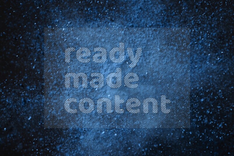 Blue powder explosion on black background